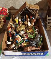 Full overview of the boxed set containing various composite nativity figurines and a stable structure.