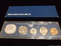 Photo of the full 1966 US Special Mint Set box and all 5 coins in a plastic holder with US eagle and text.