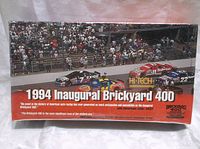 Front view of unopened trading card set box showing racing cars and event name