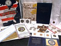 Overview of lot including coin albums, coin books, loose coins, and collectible coins with certificates and presentation cards.