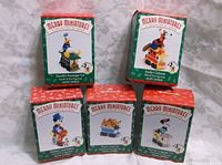 Merry Miniatures boxes for the 5-piece Mickey and friends train set, showing individual character names and packaging.