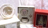 Three items displayed together; ivory and gold Lenox jewelry box, pendant in box, and Christmas tree ornament in red box
