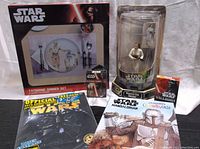 Lot contents showing all items including Tatooine Dinner Set box, Princess Leia figure in packaging, two playing cards decks, magazines and coloring books.