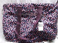 Front view of Vera Bradley Berry Burst tote bag showing floral pattern, two shoulder straps, front zippered pocket, and original tag attached.