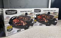 Two boxed new Granitestone Diamond electric skillets side by side, showing the product packaging and features.