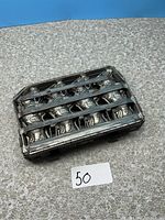 Top view of closed antique metal chocolate bunny mold showing six rabbit shapes