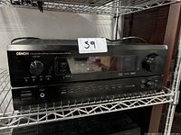 Front view of Denon AVR-3802 showing the power button, function knob, headphone jack, and control buttons.