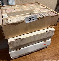 Stacked boxes filled with sport trading cards in sleeves and stacked tightly together.