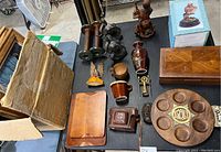 Wide view of assorted wooden and decorative items on table with cardboard box