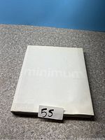 Front cover of the white hardcover book titled 'Minimum' with embossed text.