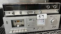Panasonic RE-7670 FM-AM Multiplex Stereo Receiver on top with visible control knobs and Akai CS-M01 cassette deck below with cassette tape inside and VU meter