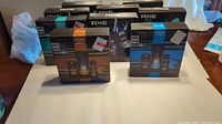 Nine unopened Axe men's body care gift sets displayed together showing mixed scents and sealed condition.