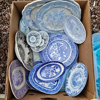 Box with assortment of transferware plates, mainly blue and purple, including Blue Willow pattern