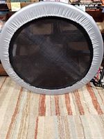 Front view of the 36-inch mini trampoline showing black jumping mat and silver-gray padded edge