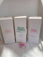 Three white boxes with Precious Moments logos indicating original packaging for the collectibles in lot.