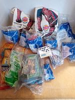 Lot of 13 Burger King vintage toys from various franchises in original plastic bags and boxes.