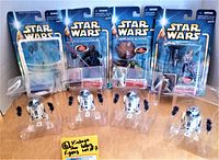Lot of 7 Star Wars Hasbro 2002 figures including 4 R2-D2s, Darth Maul, Yoda and Luke Skywalker in original packaging with visible wear.