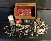Full layout showing wooden box open with red velvet interior and all pieces spread on black background