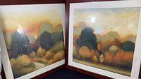 Photo showing two large framed Holman art prints titled 'Within the Grove' with autumn-themed trees and colored foliage.