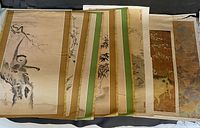 Overview of stacked vintage animal prints with visible decorative borders and aged paper