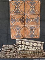 Photo showing three pieces of vintage Polynesian tapa bark artwork with varying patterns and sizes.