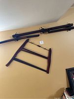 Wide shot showing the large hand saw and wooden yoke mounted on the wall