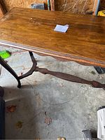 Top surface of antique wooden table showing multiple water marks and blemishes.