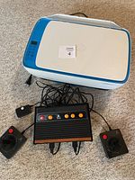 Top view of HP DeskJet printer with scanner lid closed and Atari Flashback console with two joysticks placed in front