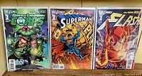 Front covers of Green Lantern Corps #1, Superman #1, and The Flash #1 comics from DC's The New 52 series displayed side by side.