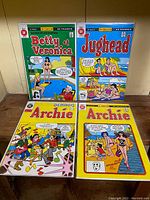 Four French language Archie Comics displayed flat: Betty et Veronica #134, Jughead #114, Archie #57 (B&W), Archie #132. Covers are vibrant and represent colorful and black & white editions.