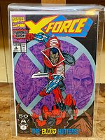 Front cover of Marvel X-Force #2 comic book showing character fighting and title/logo prominently displayed.