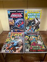 Four vintage Marvel French double issue comics with color covers and black and white interiors, featuring Dracula, Shang-Chi, Thor, and Captain America themed covers.