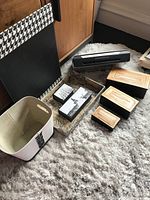 Photo of HP Officejet 150 portable printer, wooden nesting boxes, Italian desk storage boxes, leather desk blotter, and document basket arranged on carpet