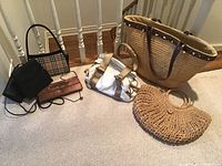 Wide view showing all six bags including straw totes, clutches, and different material handbags.