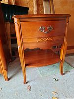 Photo of Bassett wood night table front showing drawer, handle and lower shelf.