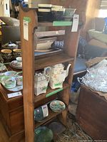 Elm wood small free standing shelf against background of assorted household items with green tag label 286. Several ceramic and glass dishes noted around and behind shelf which are not included.