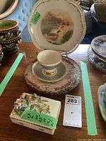Vanity box with floral 3D design in front, stacked plates with Foley cup and saucer on top, price sticker visible