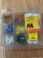 Eaton Bussmann Fuse Bonus Pack in clear plastic packaging containing multiple colored ATC blade fuses and a yellow fuse tester.
