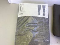 Packaged IKEA LENDA curtain panels in dark gray