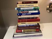 Stack of 16 Catholic Christian books showing titles and varied cover colors and styles.