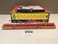Pile of six children's books stacked, including Sesame Street 8 Classic Stories boxed set and others.
