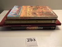 Stack of five books seen from side angle, titles visible on spine.