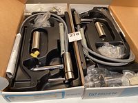 Two boxed Moen Align 6191 chrome lavatory faucets with visible faucets, hoses, and installation parts packed inside black plastic trays.