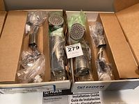 Two boxes of Moen TL2369EP Chateau chrome tub/shower remodel trim kit components wrapped in plastic with installation guide included inside box.