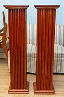 Front view of both ribbed column stands side by side showing overall design