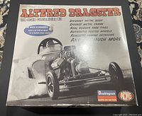 Front view of boxed kit showing the vintage style design of an Altered Dragster 1:18 scale model with text highlighting diecast metal body and frame, real rubber race tires, authentic period wheels, and realistic engine detailing.