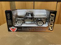 Front view of the sealed diecast silver truck coin bank in display box with clear plastic window showing the truck model inside and '2000' and Canadian Tire logo on the box.