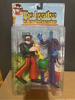 Front view of the Beatles Yellow Submarine Ringo figure in sealed original packaging showing figure and accessory trumpet inside clear plastic blister.