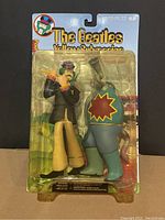 Front view of blister package showing Paul figure alongside Sucking Monster, sealed on branded Yellow Submarine backing card.