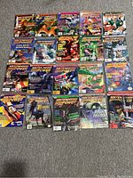 Photo showing 20 Nintendo Power magazines laid out on floor, covers visible with various Nintendo games from the 1990s.